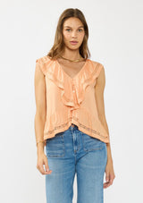 [Color: Sorbet] A front facing image of a brunette model wearing an orange flutter sleeve top with lace trims, a button front, and a ruffle trimmed hem.