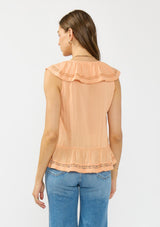 [Color: Sorbet] A back facing image of a brunette model wearing an orange flutter sleeve top with lace trims, a button front, and a ruffle trimmed hem. Styled with a blue patch pocket denim. 