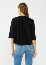 [Color: Black/Dusty Rose] A back facing image of a brunette model wearing a black embroidered top with flowy wide sleeves and a v neckline. 