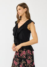 [Color: Black] A side facing image of a brunette model wearing a black flutter sleeve top with lace trims, a button front, and a ruffle trimmed hem.