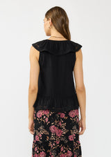 [Color: Black] A back facing image of a brunette model wearing a black flutter sleeve top with lace trims, a button front, and a ruffle trimmed hem.