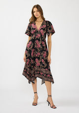 [Color: Black/Dusty Rose] A front facing image of a brunette model wearing a black and pink floral print midi dress with short sleeves, a v neckline, and a handkerchief hemline. 