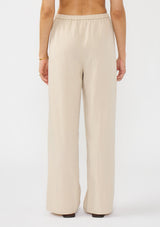 [Color: Sand] A back facing image of a tencel blend beige drawstring pant with an elastic waistband and side pockets. 