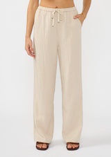 [Color: Sand] A front facing image of a tencel blend beige drawstring pant with an elastic waistband and side pockets. 