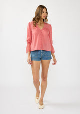 [Color: Dark Rose] A front facing image of a brunette model wearing a pink bohemian lace trim blouse with a v neckline and button front. 