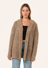 [Color: Mocha] A front facing image of a blonde model wearing a fuzzy brown boucle hooded cardigan. With long sleeves and an open front. 