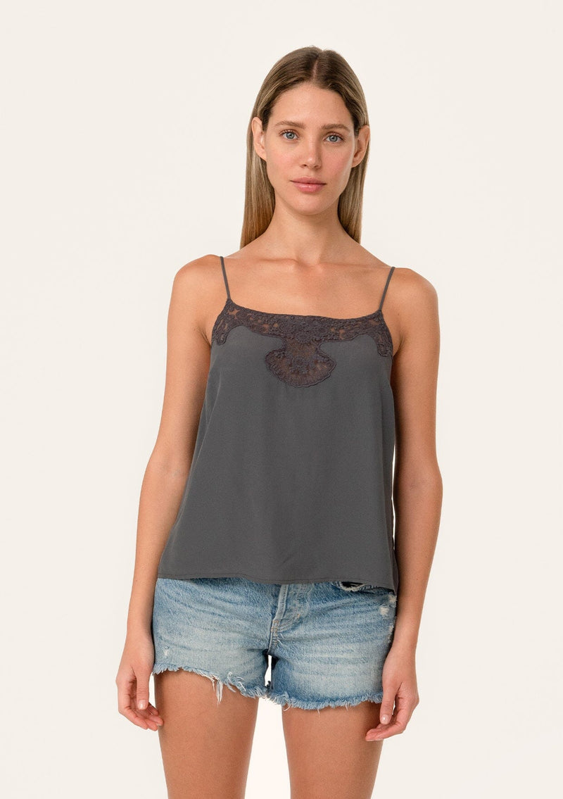 [Color: Pewter] A front facing image of a blonde model wearing a grey bohemian camisole with adjustable spaghetti straps, a scoop neckline, a button up back, and lace detail.