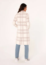 [Color: Off White/Mink] A full body front facing image of a brunette model wearing a cozy and fuzzy sweater coat in a cream and pink plaid pattern. With long sleeves, a notched lapel, side patch pockets, and a button front.