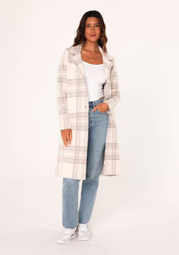 [Color: Off White/Mink] A full body front facing image of a brunette model wearing a cozy and fuzzy sweater coat in a cream and pink plaid pattern. With long sleeves, a notched lapel, side patch pockets, and a button front.
