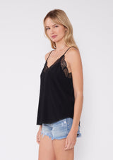 [Color: Black] Girl wearing a black lace trim camisole.