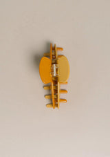 [Color: Citrus] An image of a large yellow two tone hair claw clip from Nat and Noor. 