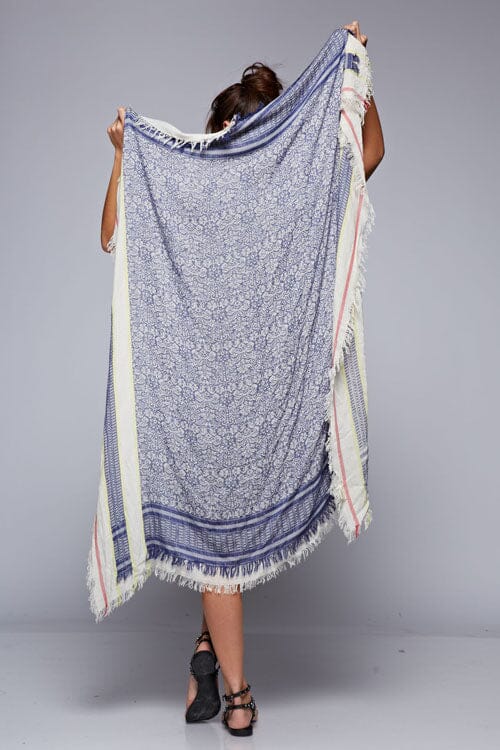 [Color: Blue] An image of a blue printed boho scarf with frayed edges.