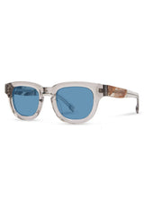 [Color: Ice Water]: Thick sunglasses with a blue lens in a light grey  tone acetate frame. Designed in Italian cellulose acetate with stainless steel temples.