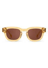 [Color: Butter]: Thick sunglasses with a caramel lens in a light gold tone acetate frame. Designed in Italian cellulose acetate with stainless steel temples.