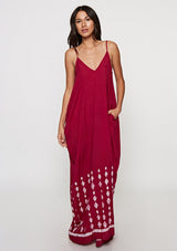 [Color: Wine] Woman wearing a burgundy bohemian maxi dress with a border print. Featuring a relaxed silhouette, a v neckline, adjustable spaghetti straps, and side pockets. 