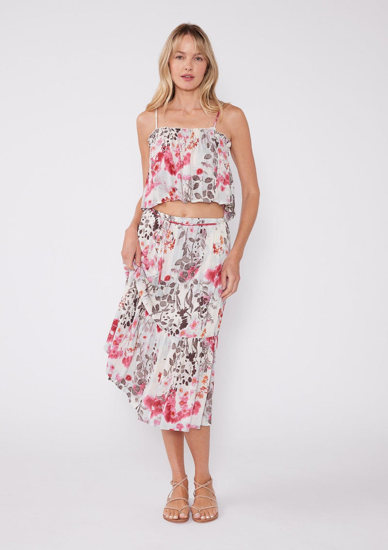 [Color: Raspberry/Mocha/LightBlue] A blonde model wearing a pink floral two piece skirt and tank top set. With a cropped camisole tank top that features spaghetti straps and a ruffled neckline. The mid length skirt features an adjustable waist tie and a tiered hemline. 