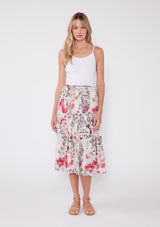 [Color: Raspberry/Mocha/LightBlue] A blonde model wearing a pink floral two piece skirt and tank top set. With a cropped camisole tank top that features spaghetti straps and a ruffled neckline. The mid length skirt features an adjustable waist tie and a tiered hemline.