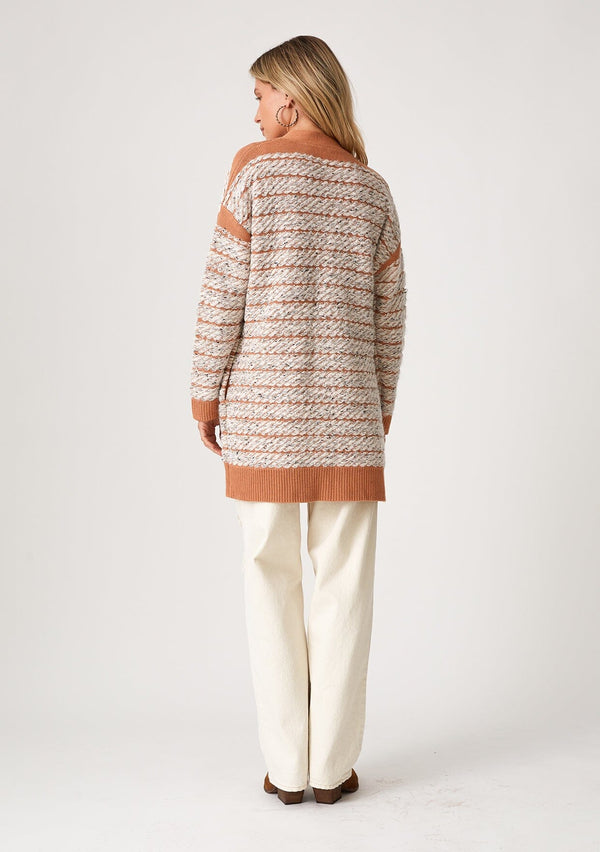 [Color: Mocha/Natural] A back facing image of a blonde model wearing a bohemian fall cardigan in a speckled loop knit stripe. With long sleeves, side pockets, an open front, and contrast brown ribbed trim. 
