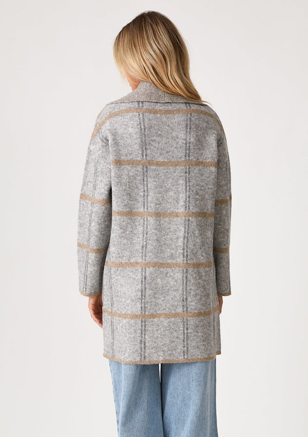 [Color: Grey/Taupe] A back facing image of a blonde model wearing a cozy fall cardigan in a grey windowpane plaid. With long sleeves, an open front, a shawl collar, and side pockets. 