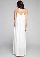 [Color: Off White] A back facing image of a brunette model wearing a white maxi dress with a relaxed fit, scoop neckline with crochet ball trim, and adjustable spaghetti straps. 