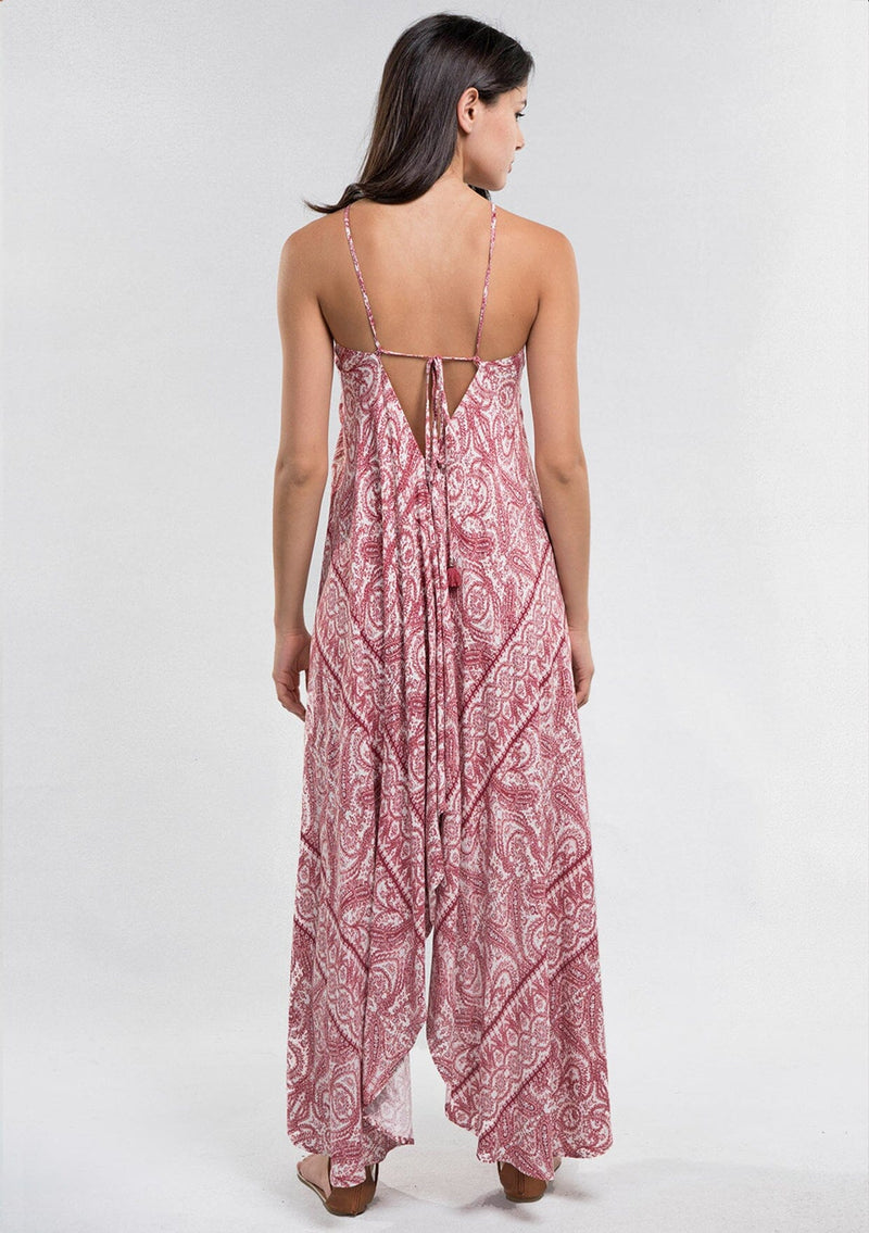 [Color: Burnt Sienna] A Brunette model wearing a bohemian red paisley maxi beach dress with spaghetti straps, keyhole front, open back with tie detail, and a flowy hem. 