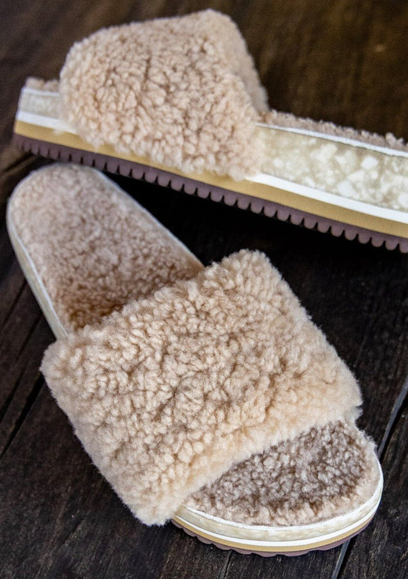 [Color: Sand] An image of a fuzzy shearling slide sandal in beige with a thick platform sole. Designed with sustainability in mind from Fleks footwear. 