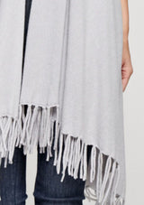 [Color: Heather Silver] A woman wearing a hooded knit fringe vest. Featuring a trending fringed hemline and an easy open front.