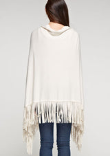 [Color: Vanilla] A front facing image of a blonde model wearing an ivory suede fringed poncho. 