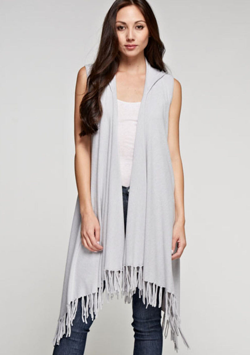 [Color: Heather Silver] A woman wearing a hooded knit fringe vest. Featuring a trending fringed hemline and an easy open front.