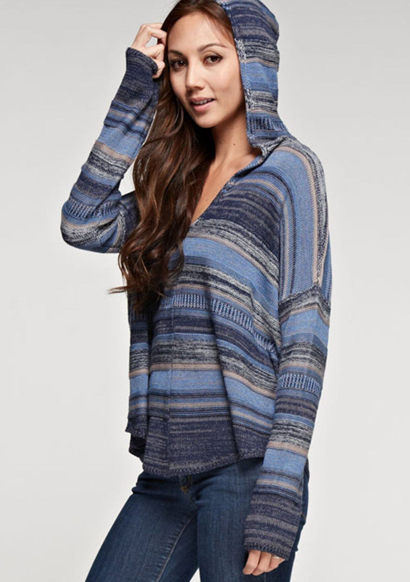 [Color: Blue Combo] A brunette model wearing a boho striped knit hoodie with a v-neckline and long sleeves. 