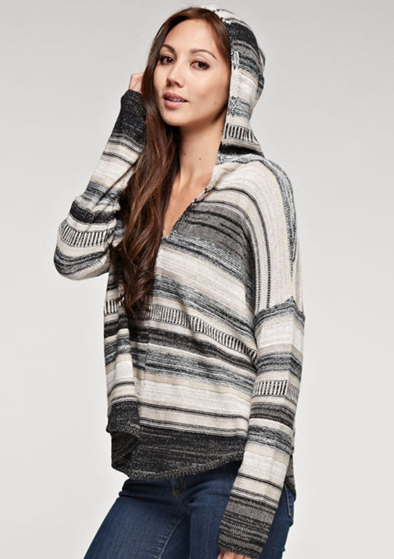 [Color: Taupe Combo] A brunette model wearing a boho striped knit hoodie with a v-neckline and long sleeves. 