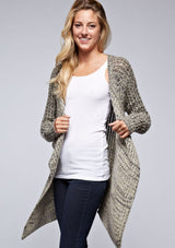 [Color: Black/Natural] A front facing image of a blonde model wearing a marled knit black and beige cardigan with a shawl collar and cozy long sleeves. A casual fall cardigan. 