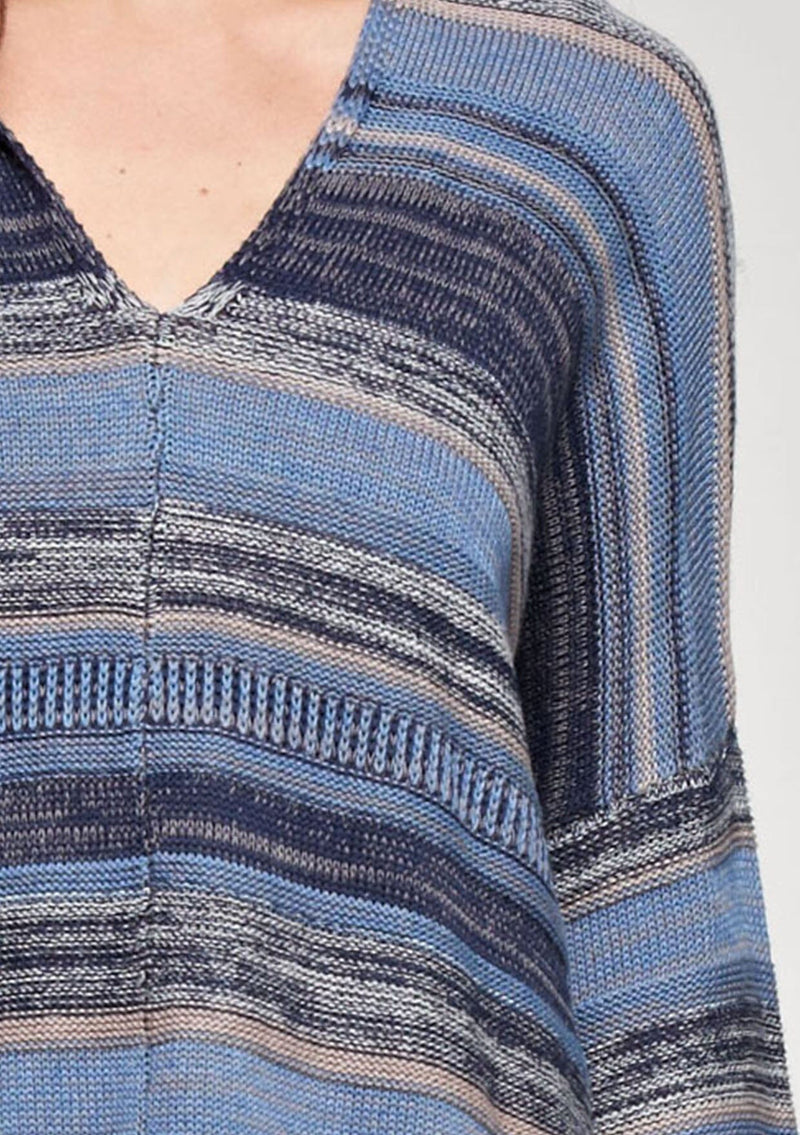 [Color: Blue Combo] A brunette model wearing a boho striped knit hoodie with a v-neckline and long sleeves. 