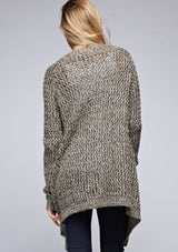 [Color: Black/Natural] A back facing image of a blonde model wearing a marled knit black and beige cardigan with a shawl collar and cozy long sleeves. A casual fall cardigan. 
