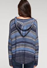 [Color: Blue Combo] A brunette model wearing a boho striped knit hoodie with a v-neckline and long sleeves. 