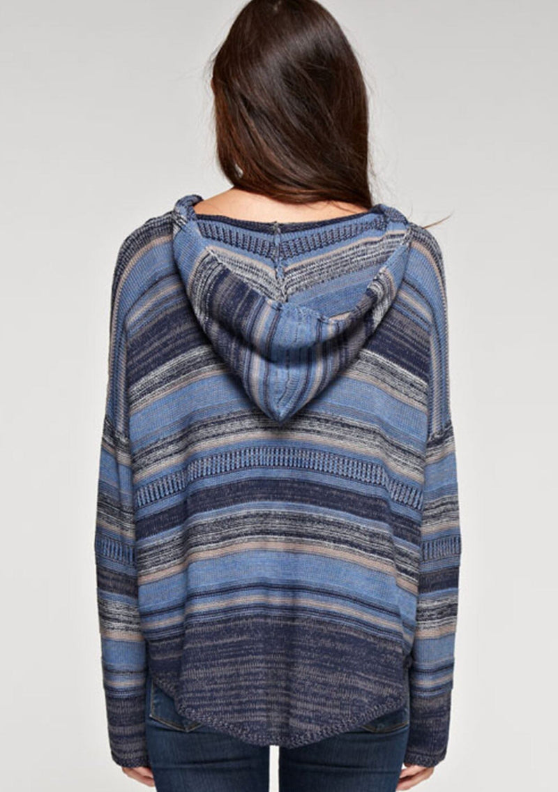 [Color: Blue Combo] A brunette model wearing a boho striped knit hoodie with a v-neckline and long sleeves. 