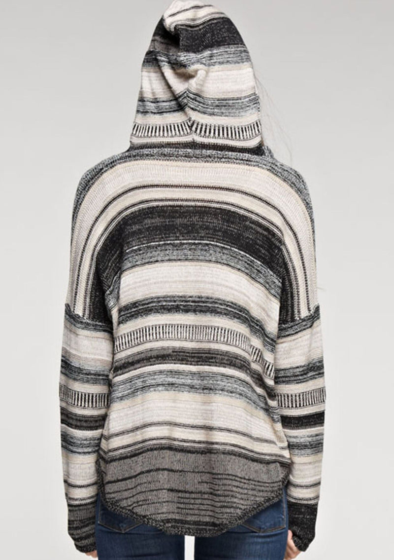 [Color: Taupe Combo] A brunette model wearing a boho striped knit hoodie with a v-neckline and long sleeves. 