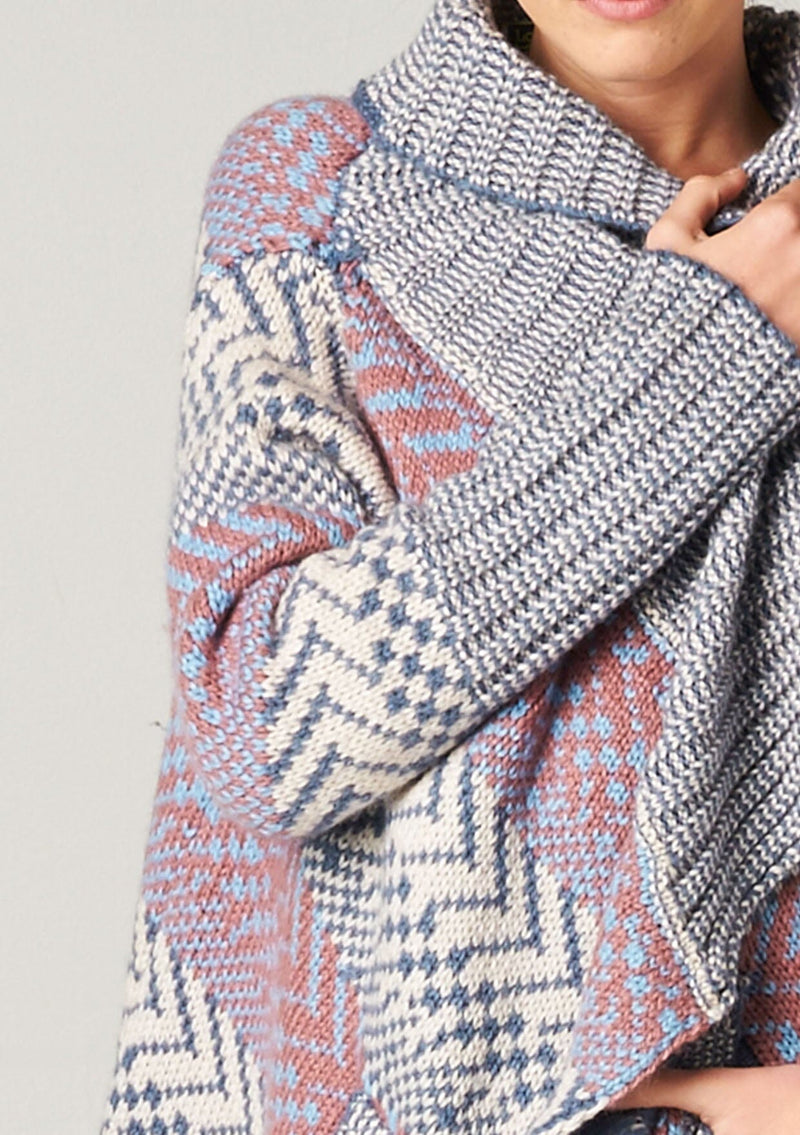 [Color: Ivory/Ocean/Rose] A blonde model wearing a boho striped cardigan with a cozy shawl collar and side pockets. A statement boho cardigan for the fall season. 