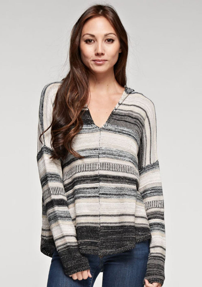 [Color: Taupe Combo] A brunette model wearing a boho striped knit hoodie with a v-neckline and long sleeves. 
