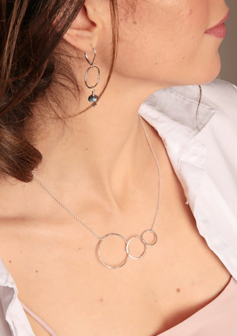 A sterling silver necklace with hammered interlocking circles suspended by a 16 inch chain. 