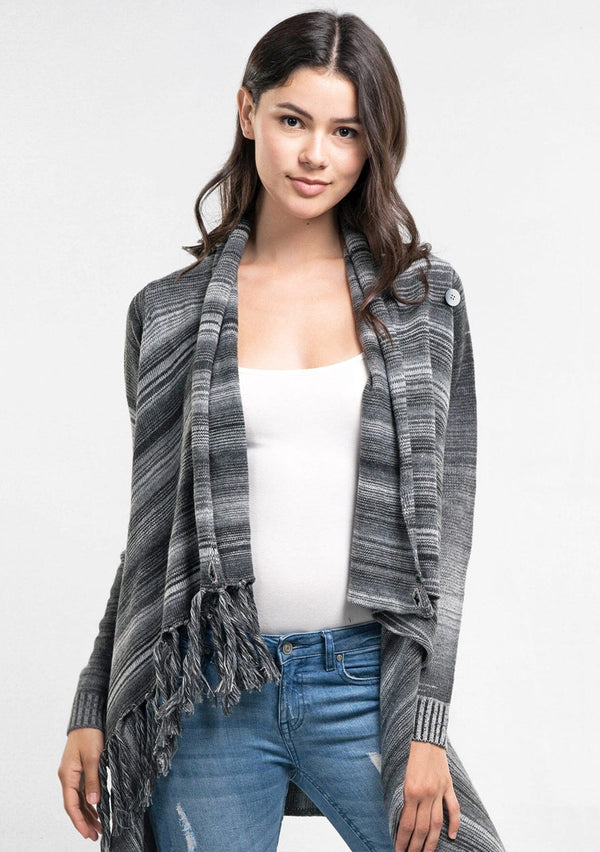 [Color: Heather Grey/Black] An image of a model wearing a striped shawl cardigan with a fringe trim and wrap button closure. 
