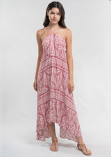 [Color: Burnt Sienna] A Brunette model wearing a bohemian red paisley maxi beach dress with spaghetti straps, keyhole front, open back with tie detail, and a flowy hem. 