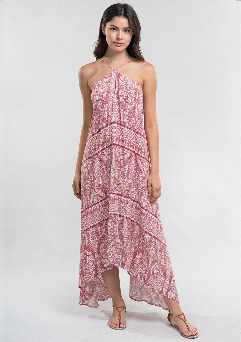 [Color: Burnt Sienna] A Brunette model wearing a bohemian red paisley maxi beach dress with spaghetti straps, keyhole front, open back with tie detail, and a flowy hem. 