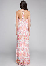 [Color: Coral/Rose/Multi] A back facing image of a brunette model wearing bohemian maxi dress with a pink geometric print, spaghetti straps, and a  racerback with tassel ties. 