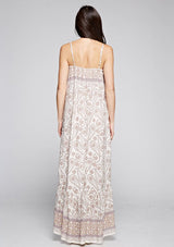 [Color: Yellow/Petal] A back facing image of a brunette model wearing a sleeveless paisley maxi dress with square neckline and adjustable spaghetti straps. 