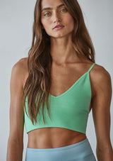 [Color: Mint Parfait] A front facing image of a brunette model wearing a basic lime green bralette cami with a slim stretchy fit and a v neckline.