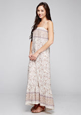 [Color: Yellow/Petal] A side facing image of a brunette model wearing a sleeveless paisley maxi dress with square neckline and adjustable spaghetti straps. 