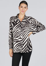 [Color: Black/Bone] A front facing image of a brunette model wearing a statement blouse with a black and white zebra print, button front, collared neck, and a relaxed, oversized fit.