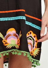 [Color: Black] A colorful embroidered black caftan mini dress with short sleeves and a v neckline.
