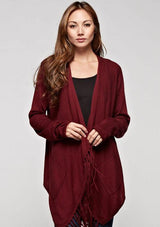 [Color: Cabernet] A brunette woman wearing  a red long sleeve cardigan with  fringe detailing. 